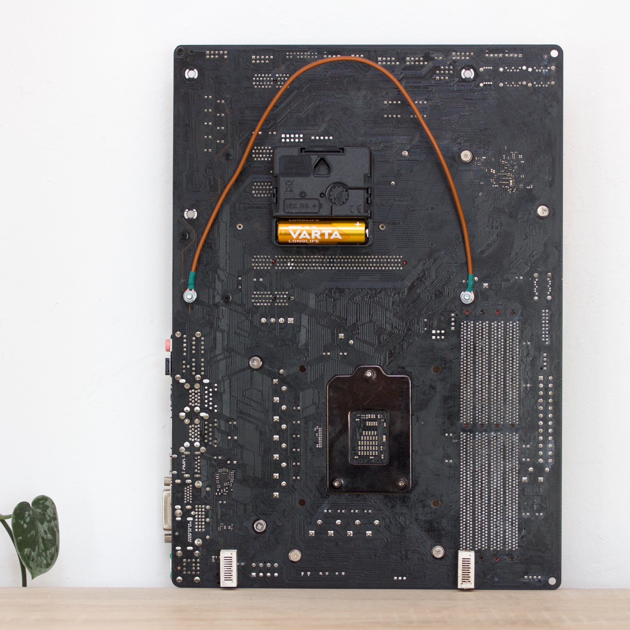 Wall Clock made of a black / dark brown circuit board with a red clock face