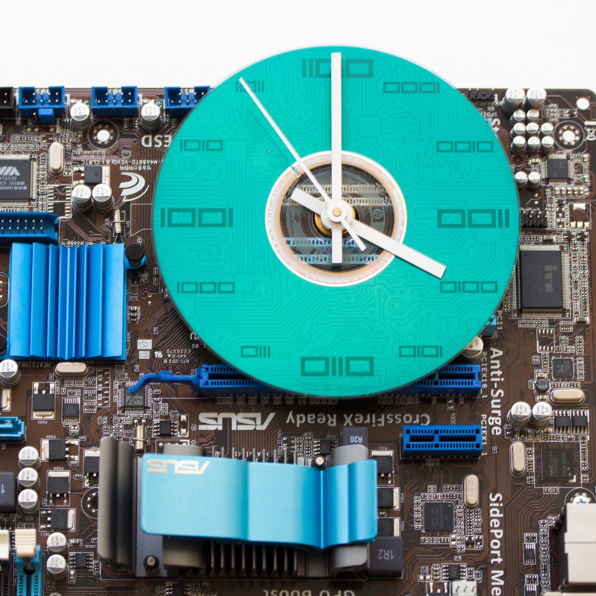Geeky Wall Clock made of a black / dark brown circuit board with a blue clock face