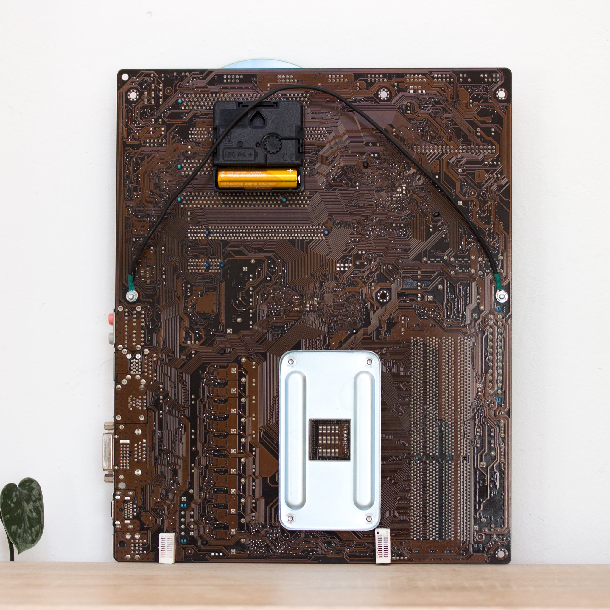 Geeky Wall Clock made of a black / dark brown circuit board with a blue clock face