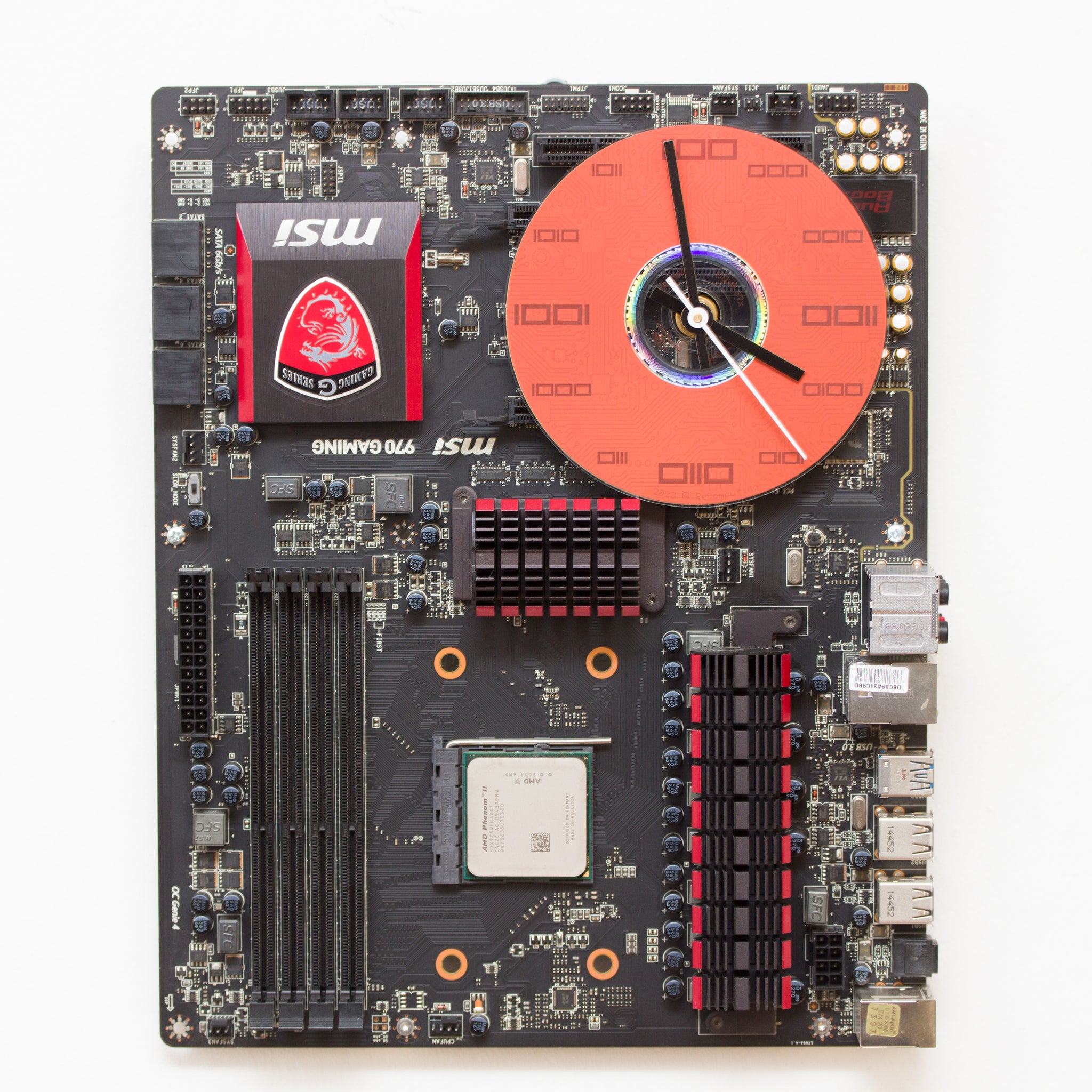 Wall Clock made of a black / dark brown circuit board with a red clock face