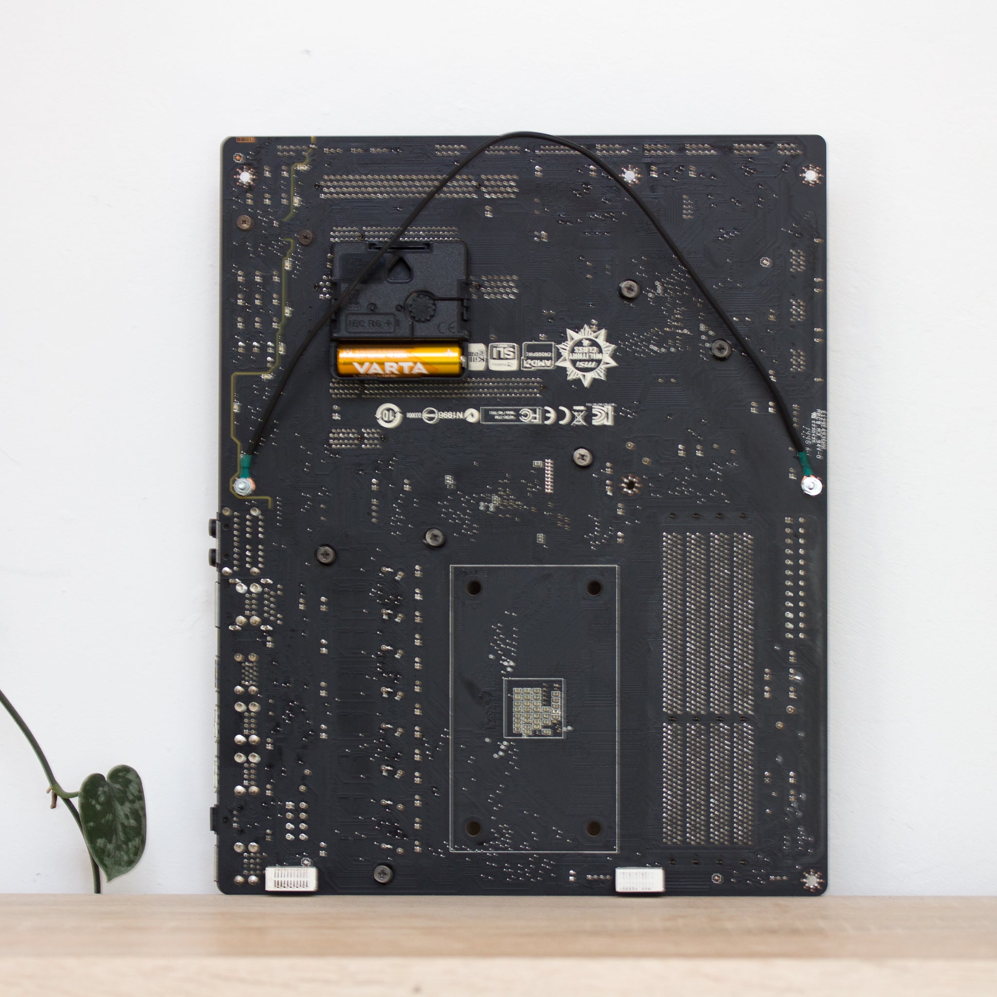 Wall Clock made of a black / dark brown circuit board with a red clock face