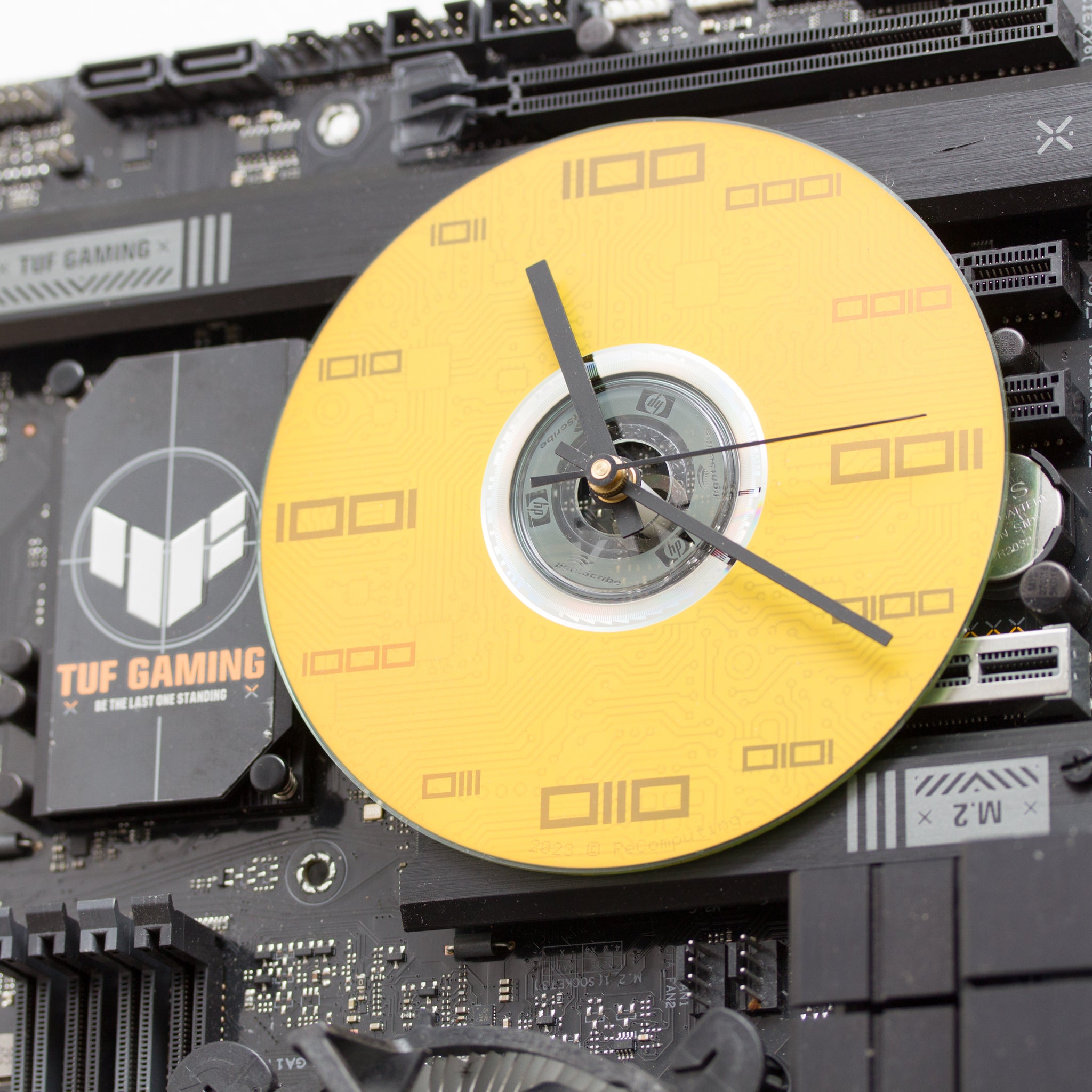 Geeky Wall Clock made of black / dark brown circuit board with yellow clock face