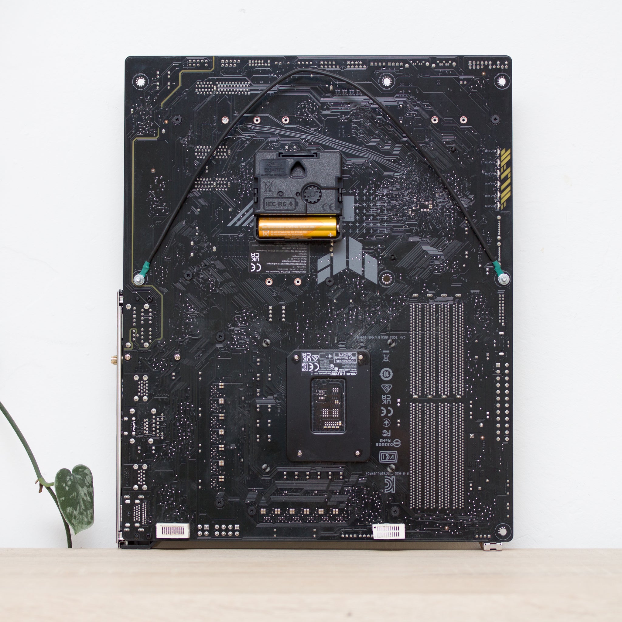 Geeky Wall Clock made of black / dark brown circuit board with yellow clock face