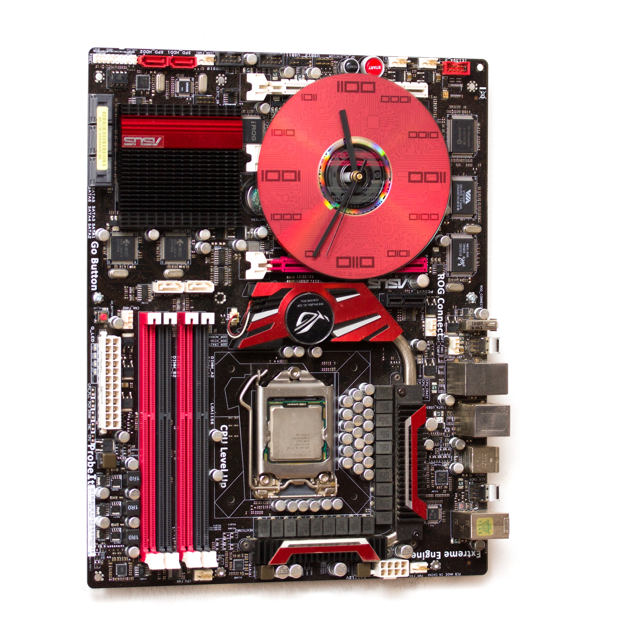 Geeky Wall Clock made of a black / dark brown circuit board with a red clock face