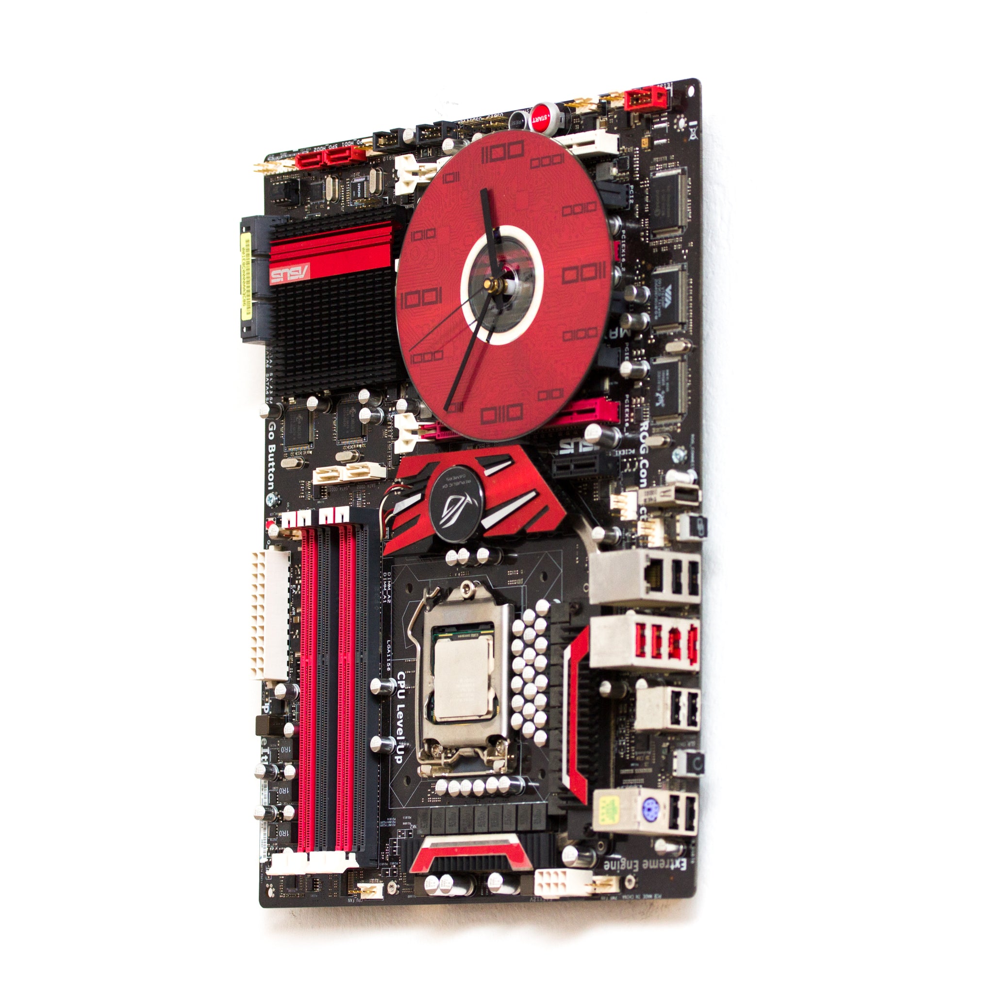 Geeky Wall Clock made of a black / dark brown circuit board with a red clock face