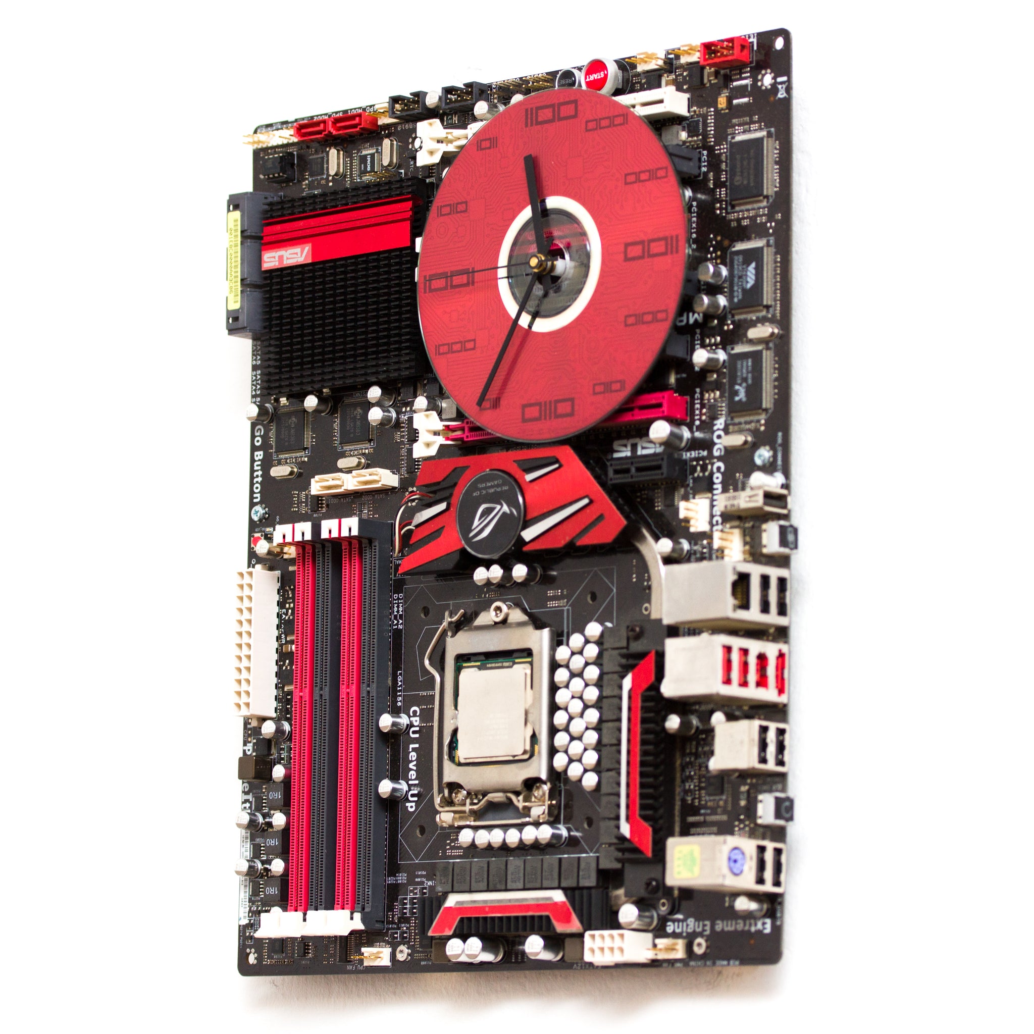 Geeky Wall Clock made of a black / dark brown circuit board with a red clock face