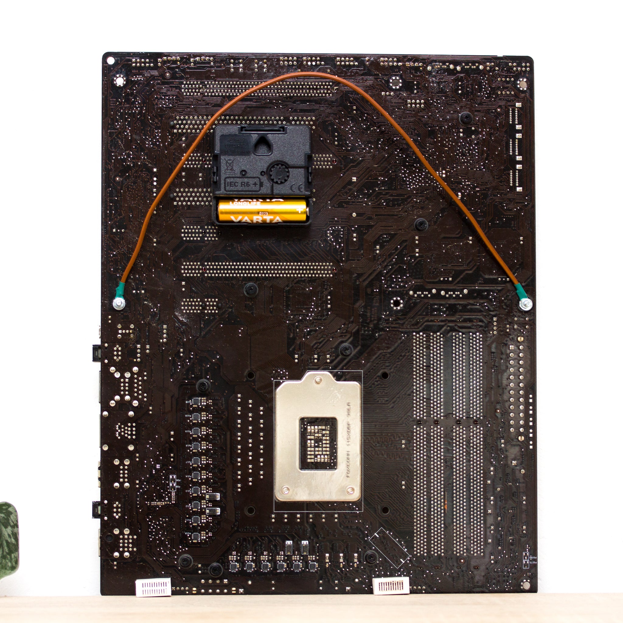 Geeky Wall Clock made of a black / dark brown circuit board with a red clock face