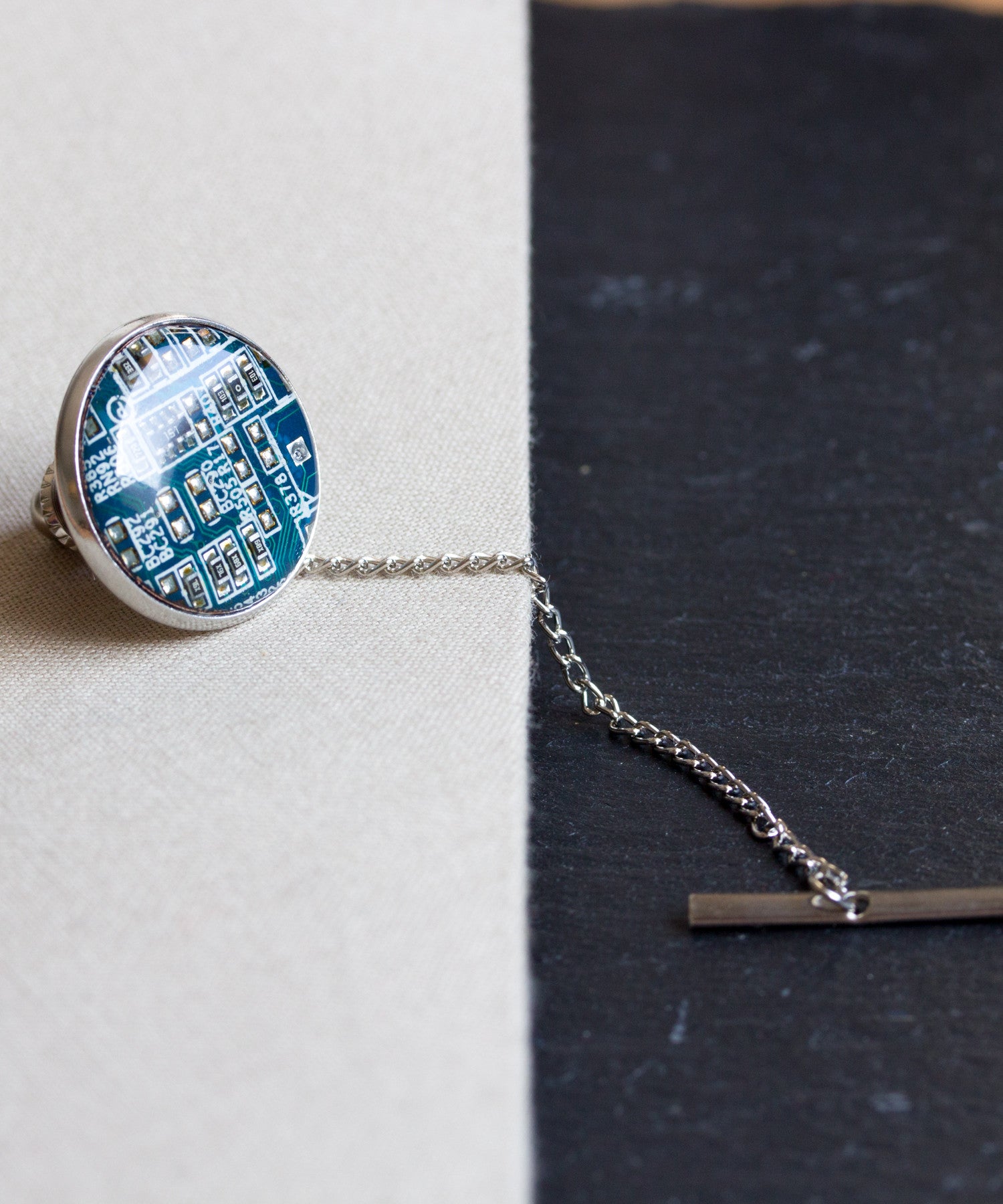 Circuit board tie pin with a chain