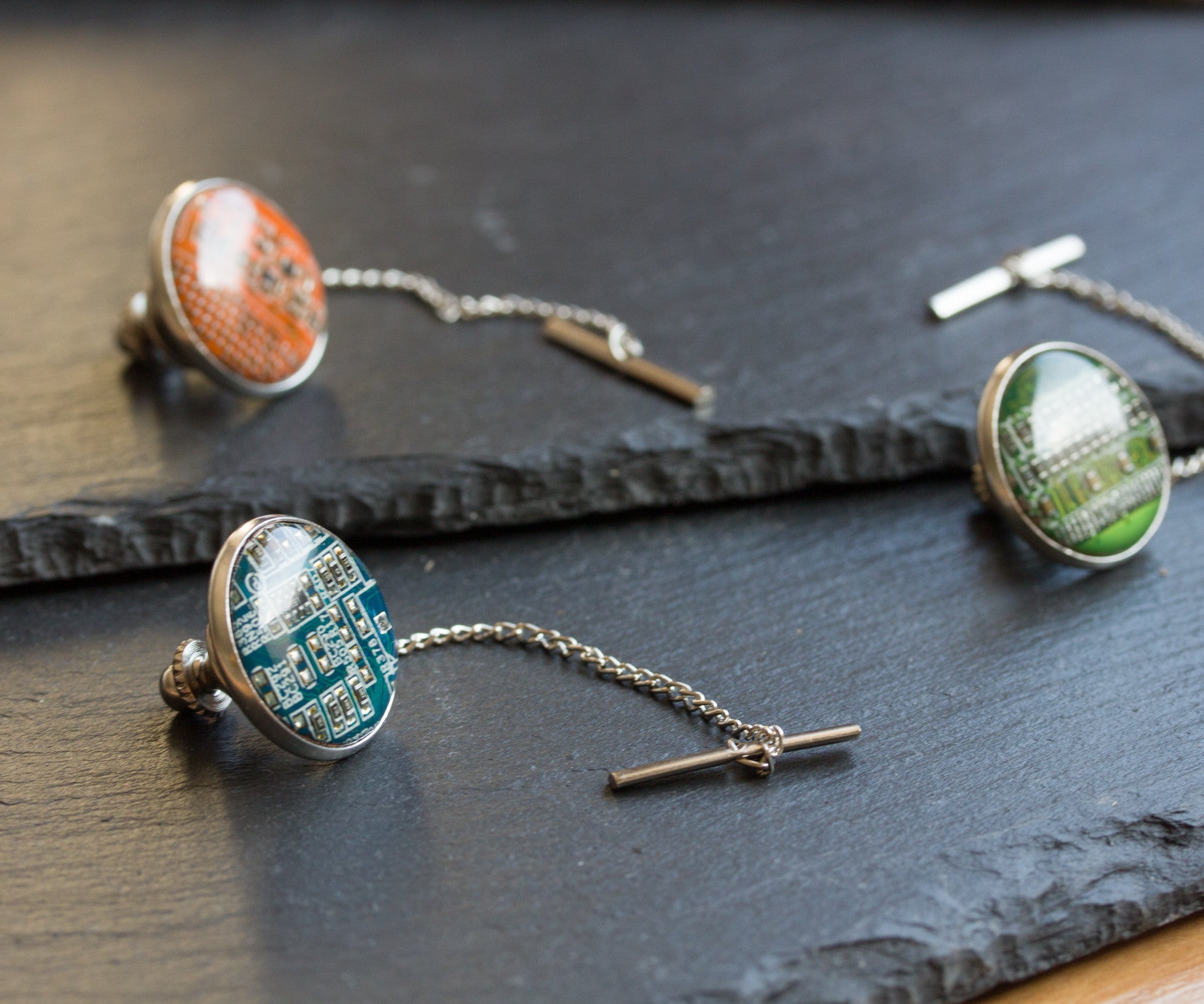 Circuit board tie pin with a chain
