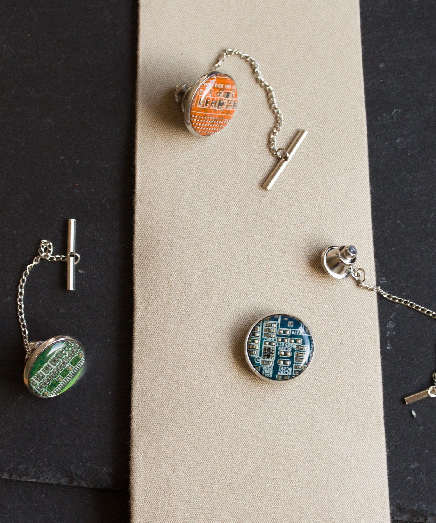 Circuit board tie pin with a chain