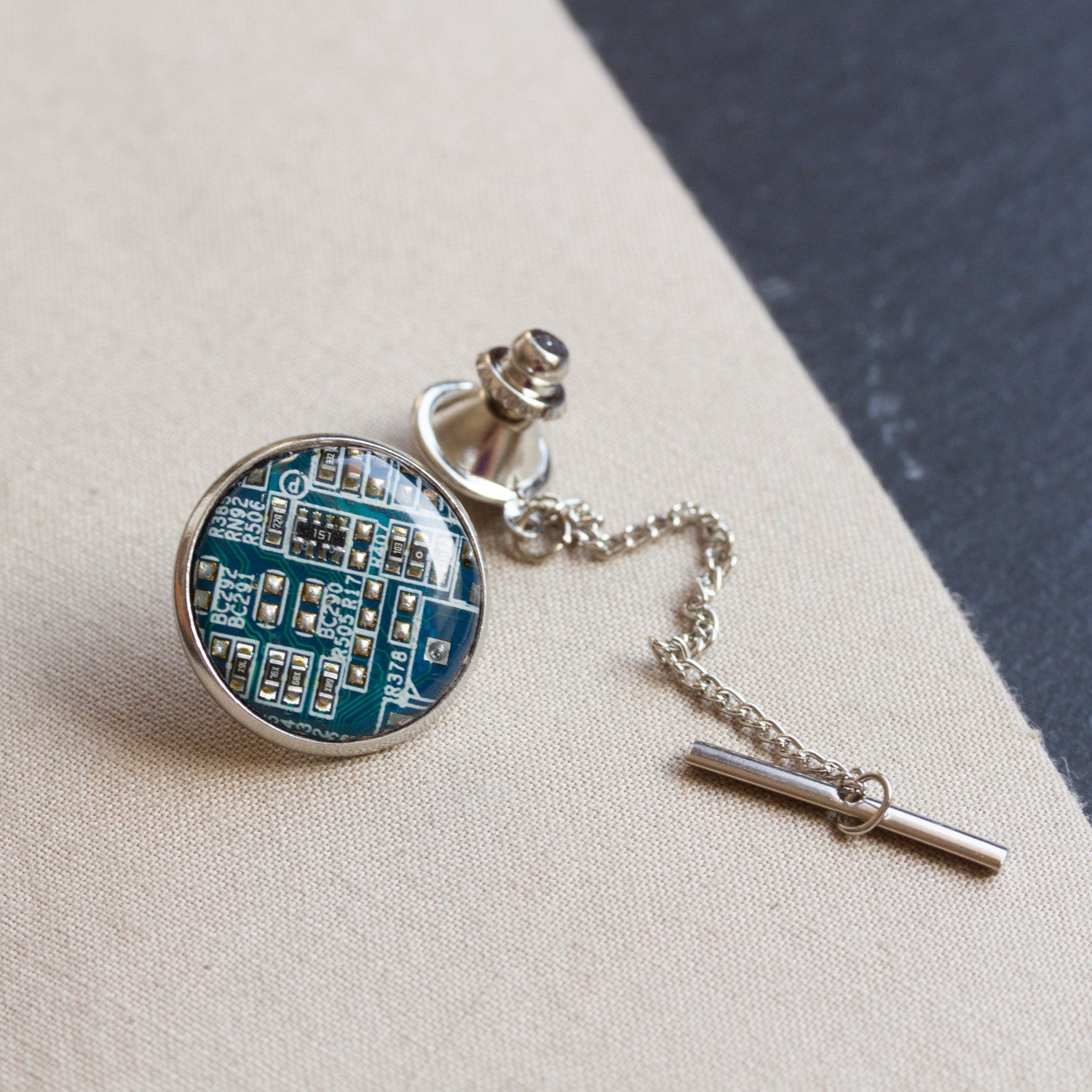 Circuit board tie pin with a chain