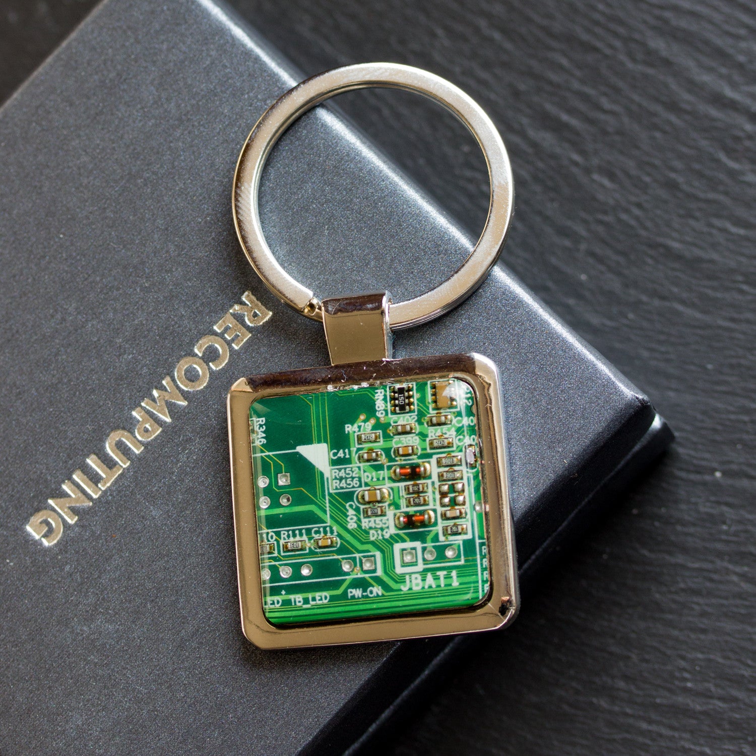 Unique keychain with circuit board piece