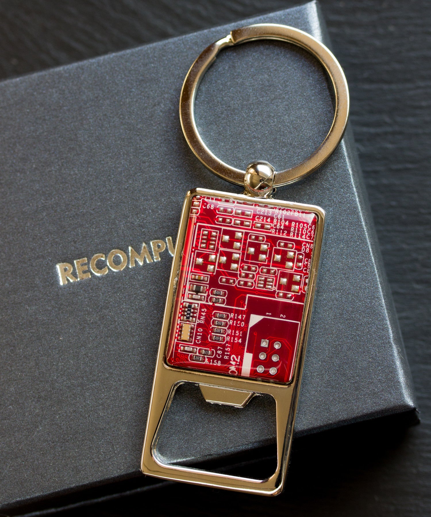 Bottle opener keychain with a circuit board piece