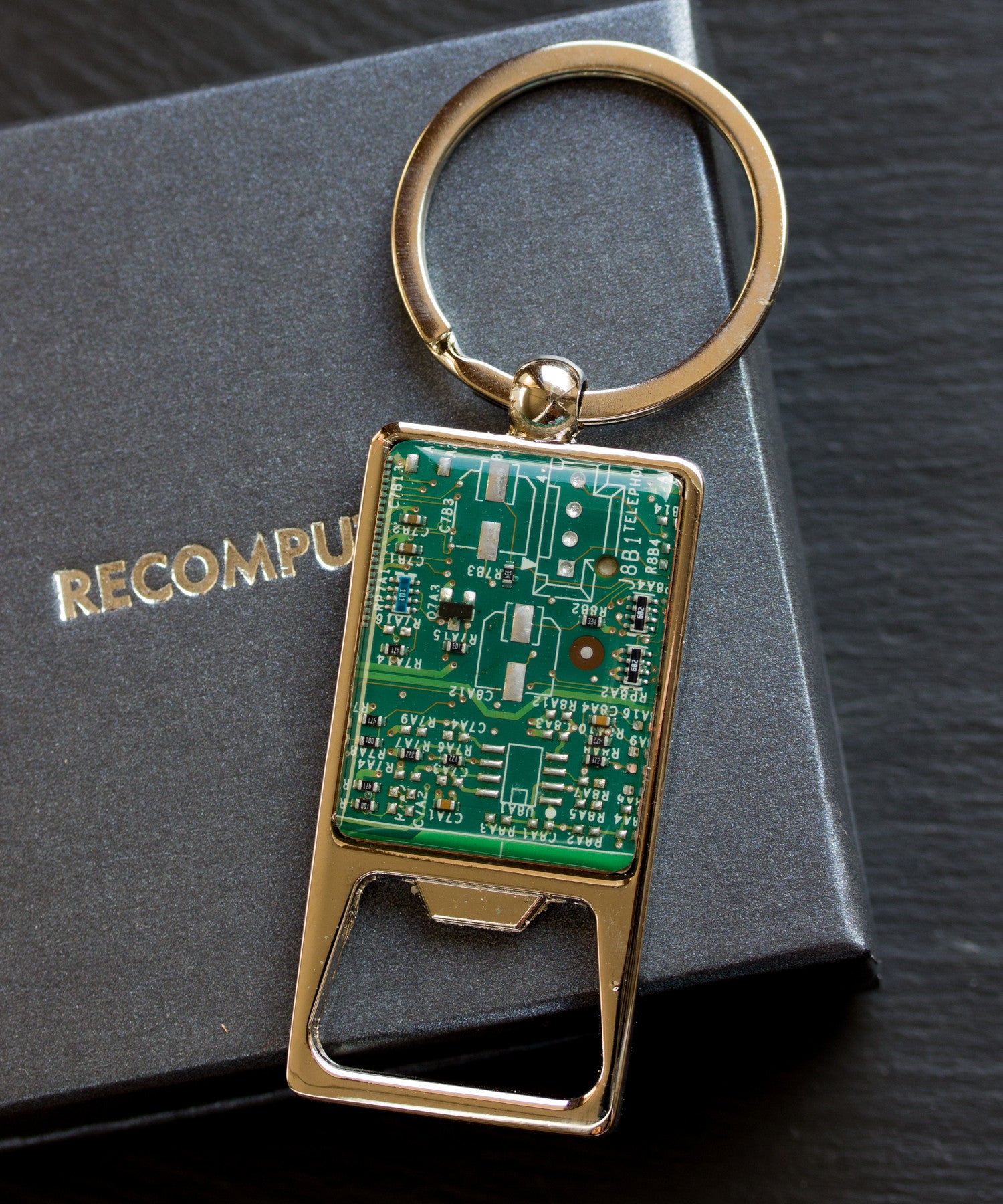 Bottle opener keychain with a circuit board piece