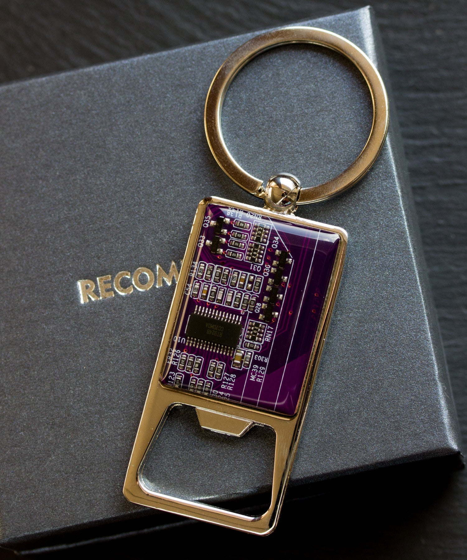 Bottle opener keychain with a circuit board piece