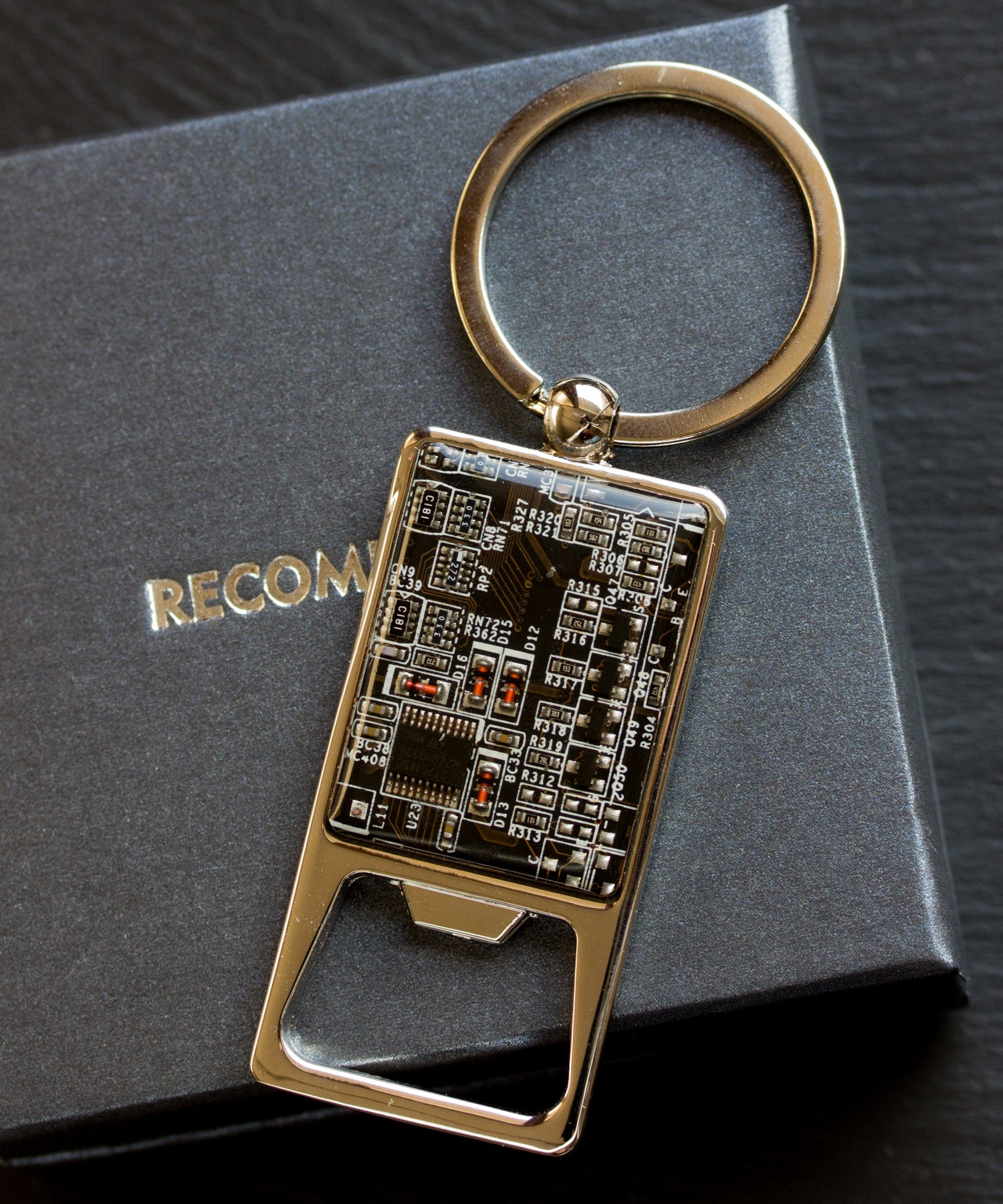 Bottle opener keychain with a circuit board piece