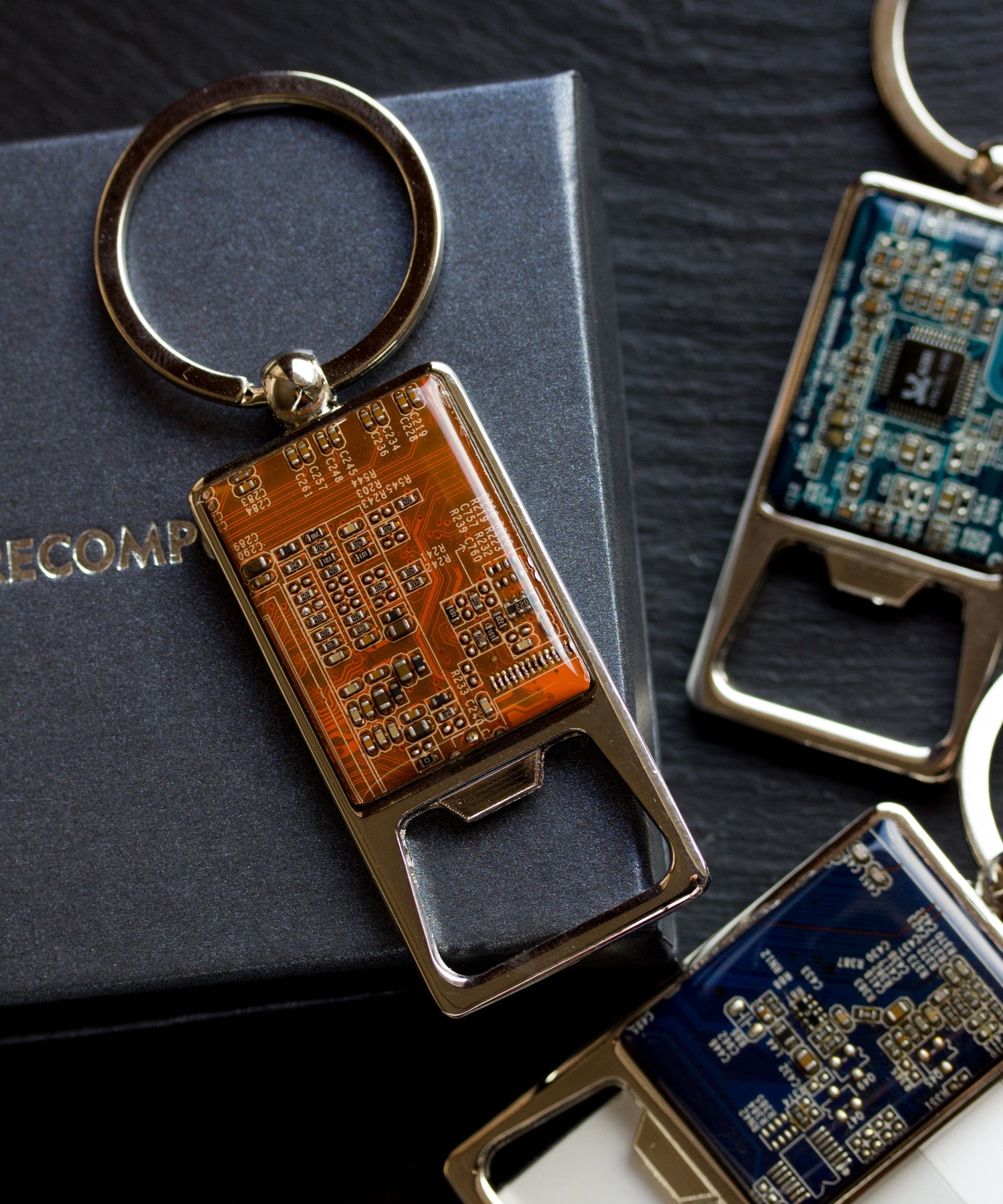 Bottle opener keychain with a circuit board piece