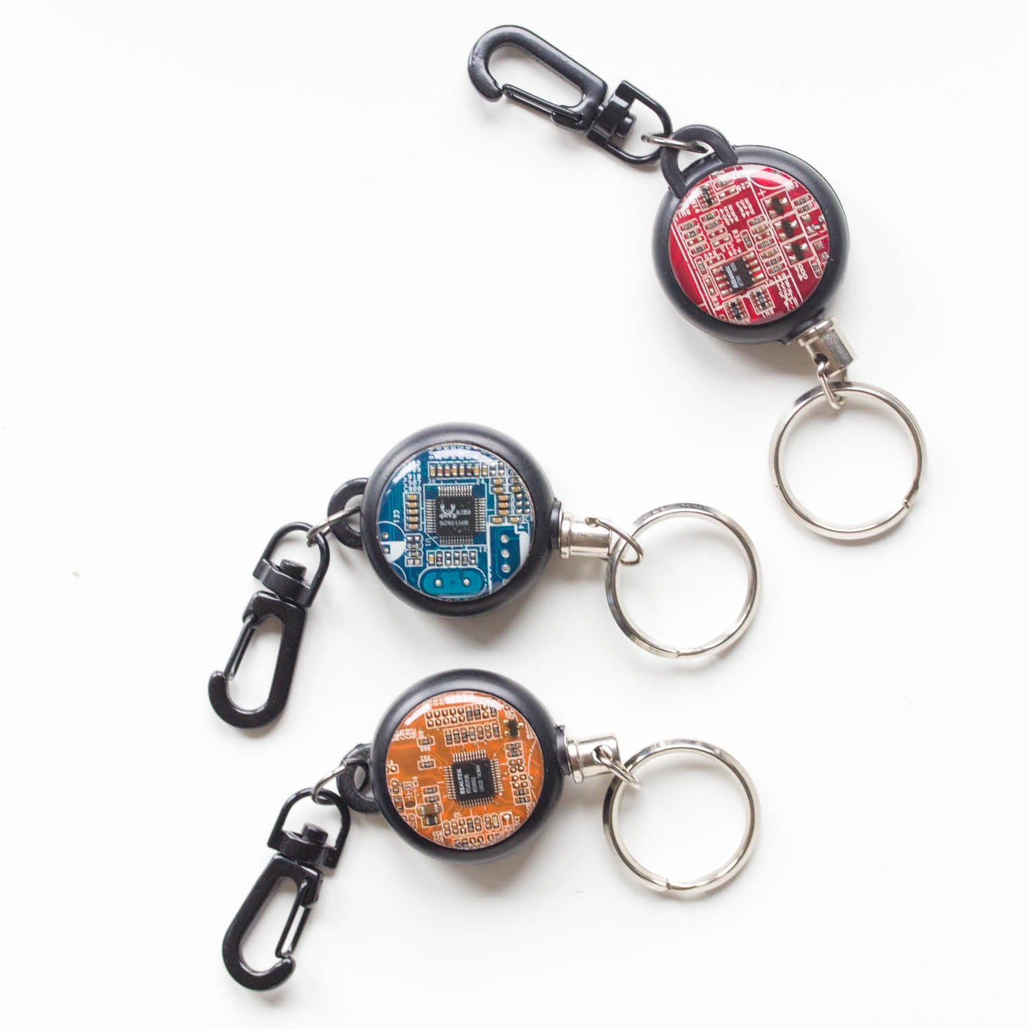 Retractable badge holder with a circuit board piece