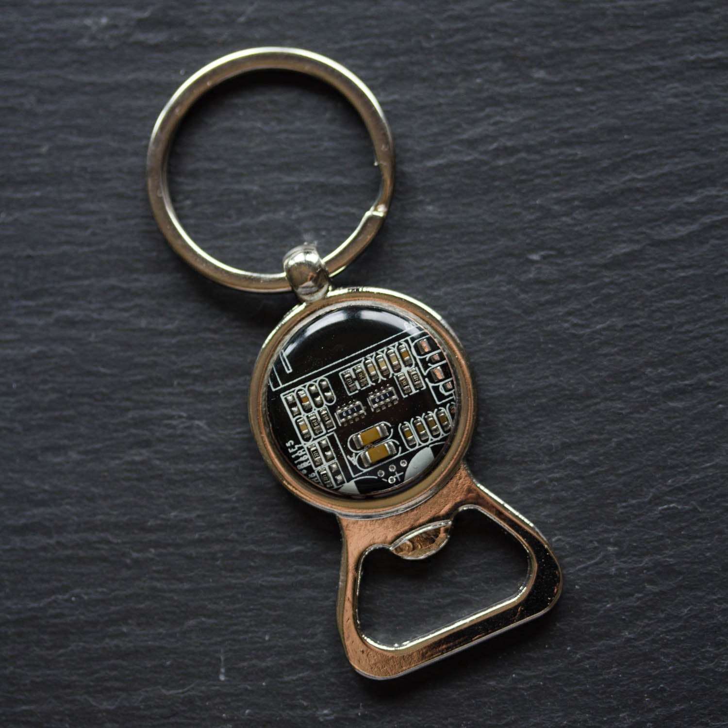 Bottle opener keychain with a circuit board