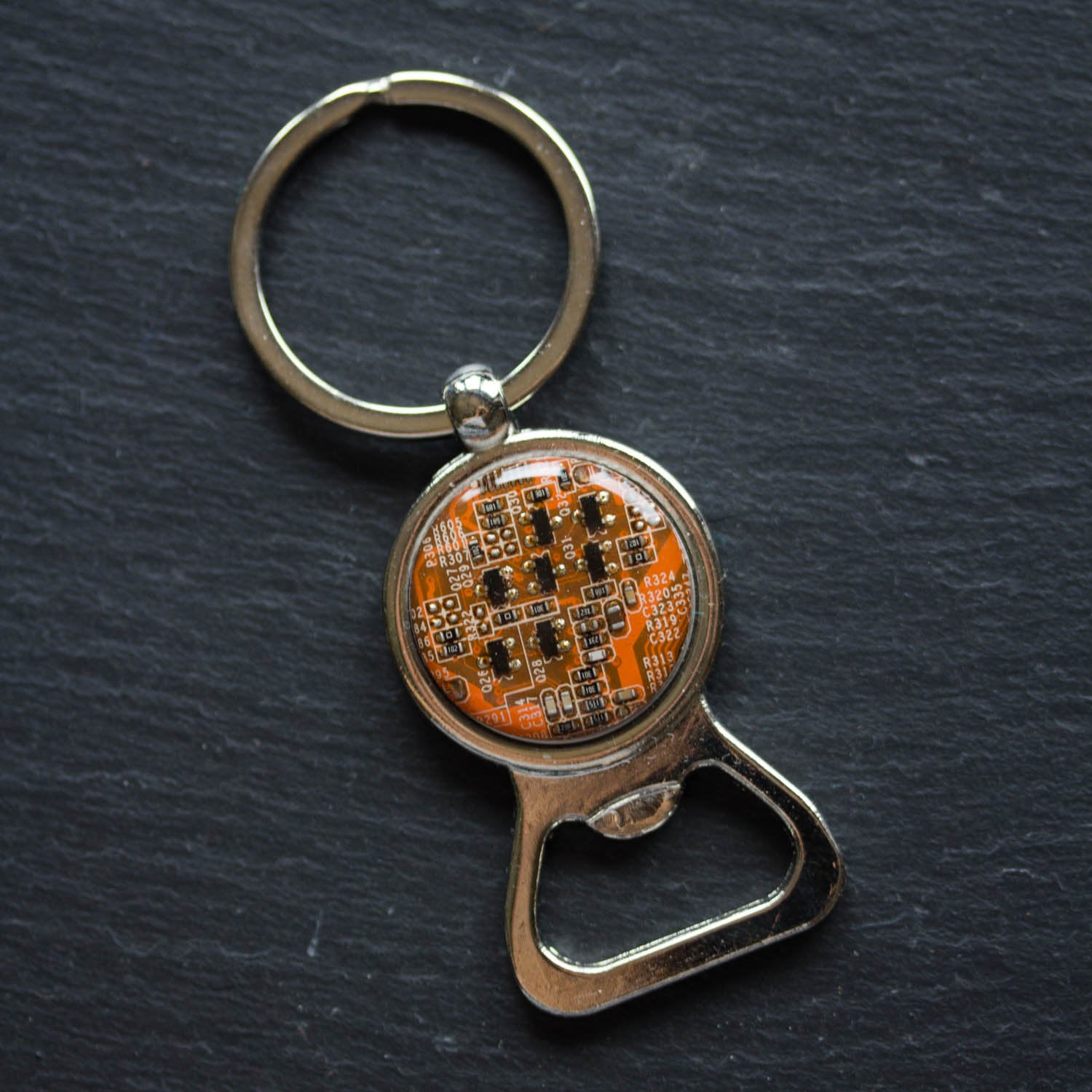 Bottle opener keychain with a circuit board