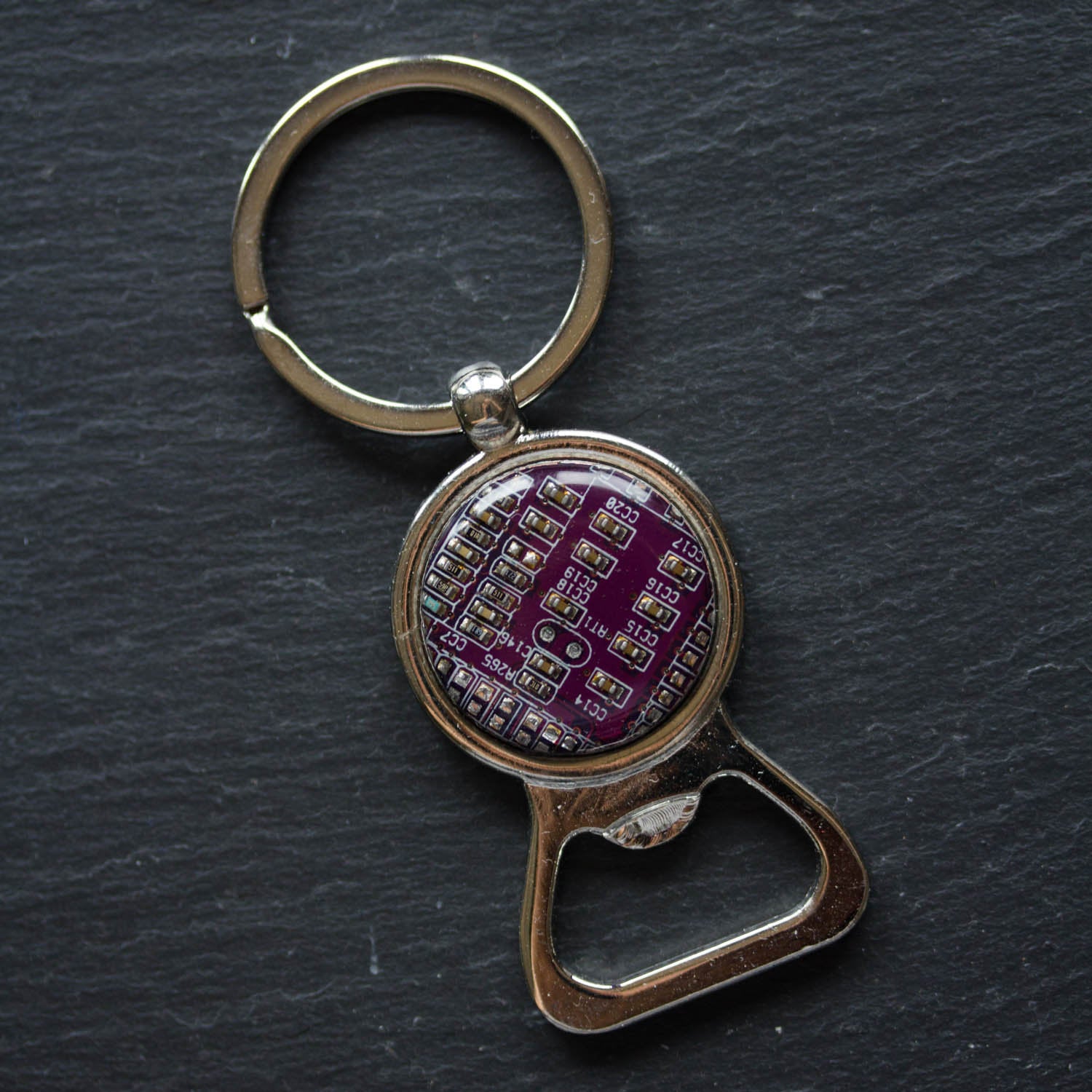 Bottle opener keychain with a circuit board