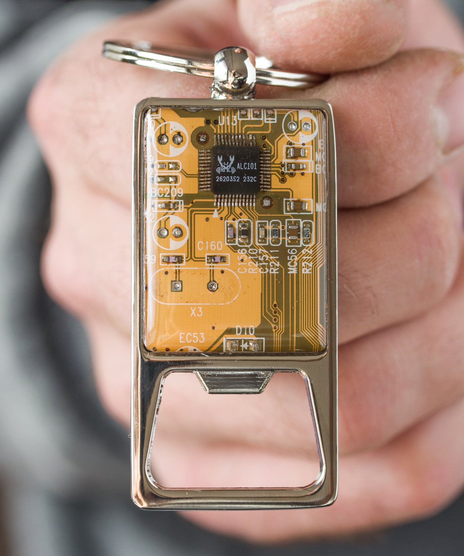 Bottle opener keychain with a circuit board piece