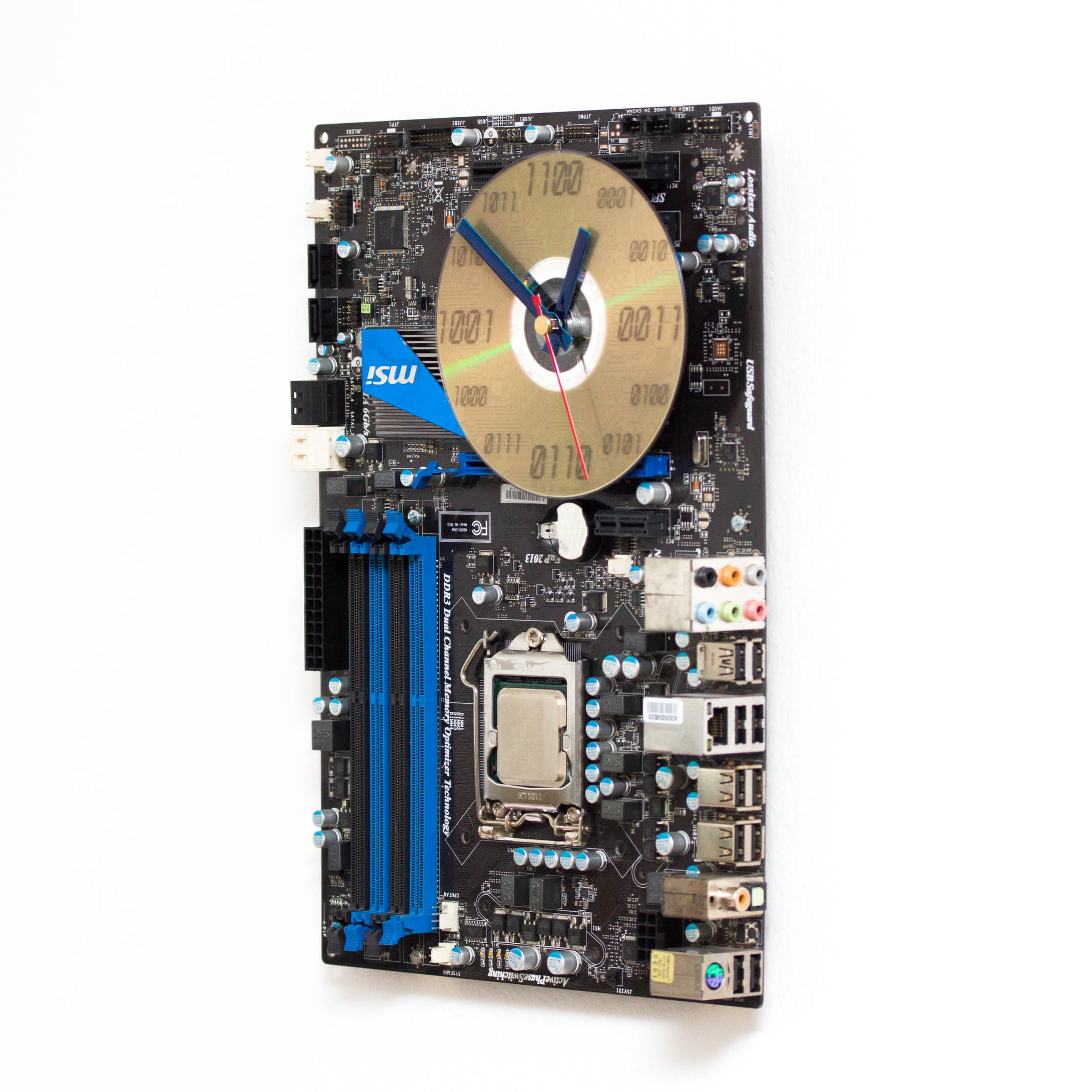 Wall clock made of dark brown circuit board with bright blue details