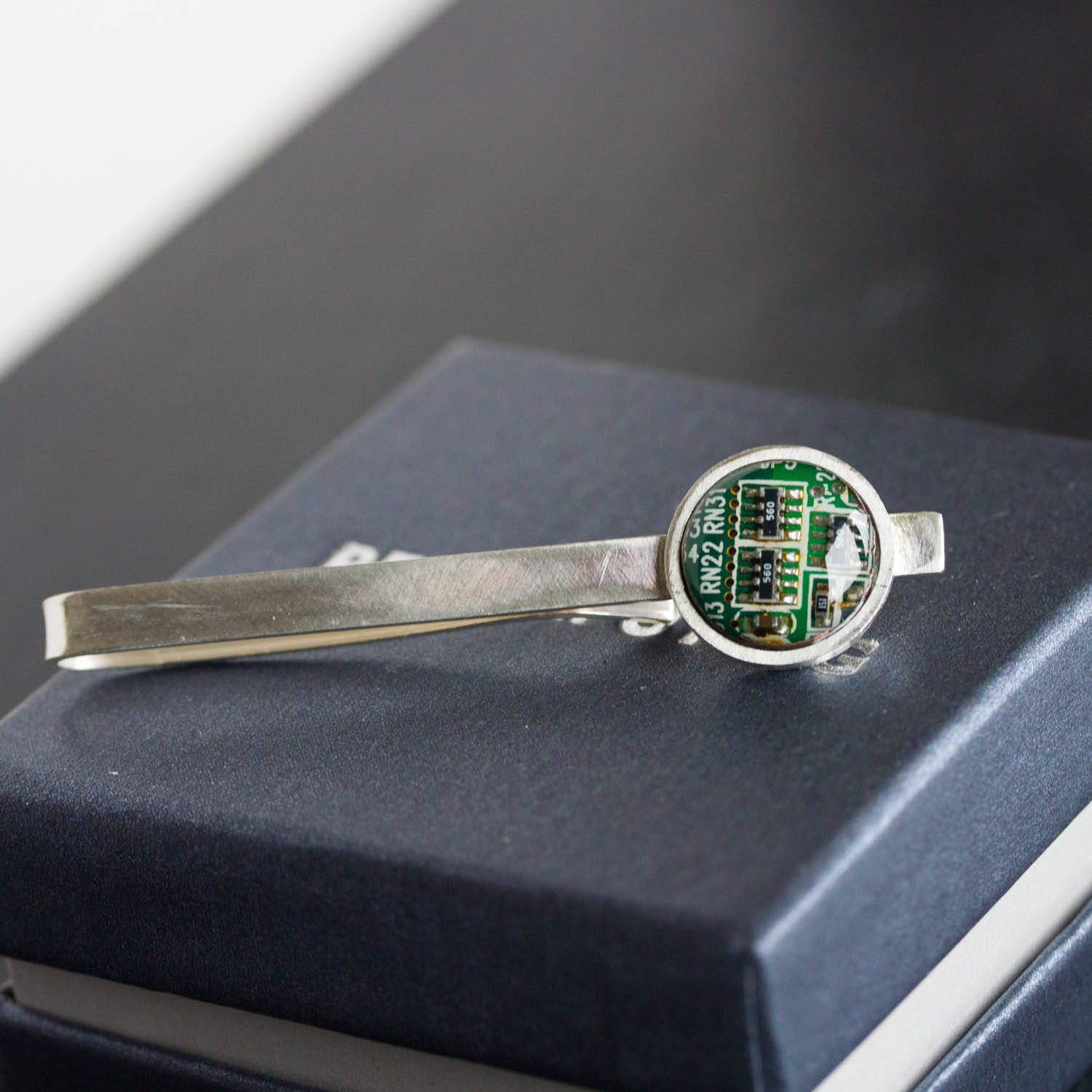 Tie bar with a circuit board piece, sterling silver